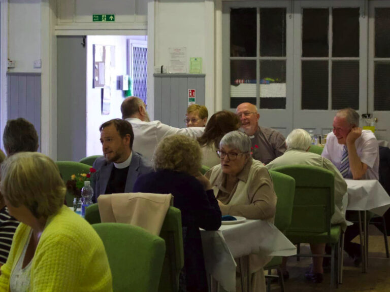 Community meeting over tables at Church